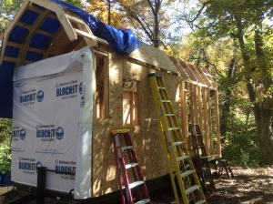 Halfway sheathed and wrapped, and with about 2/5ths of the roof sheathing in place. 